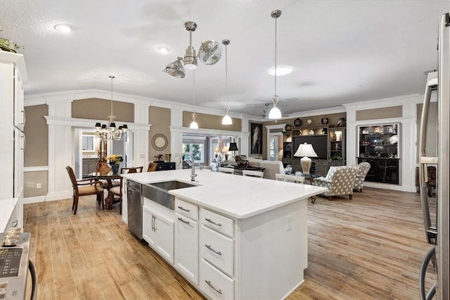 4515 Biggs Pl, The Villages, FL 32163 - kitchen with white cabinets, a notable chandelier, a sink, light wood-type flooring, and stainless steel dishwasher