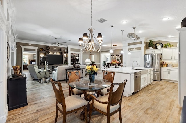 4515 Biggs Pl, The Villages, FL 32163 - dining room with visible vents, ornamental molding, light wood finished floors, and ceiling fan with notable chandelier