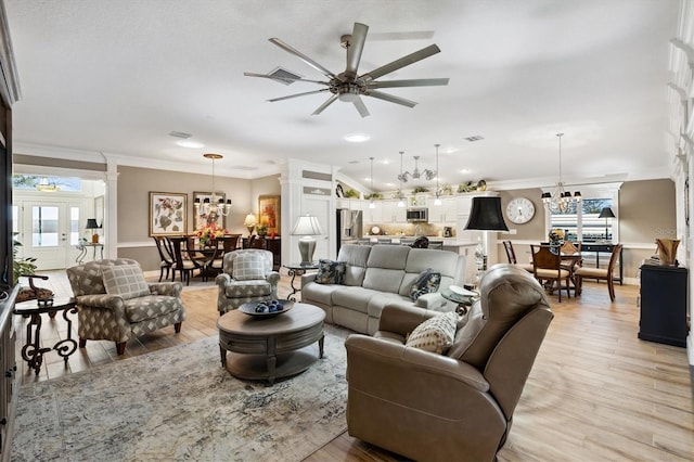 4515 Biggs Pl, The Villages, FL 32163 - living area featuring decorative columns, ornamental molding, a wealth of natural light, and ceiling fan with notable chandelier