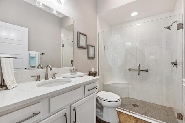 4515 Biggs Pl, The Villages, FL 32163 - full bathroom with vanity, wood finished floors, toilet, and a shower stall