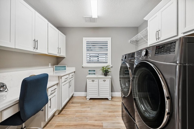 4515 Biggs Pl, The Villages, FL 32163 - washroom featuring cabinet space, light wood-style floors, separate washer and dryer, a textured ceiling, and visible vents