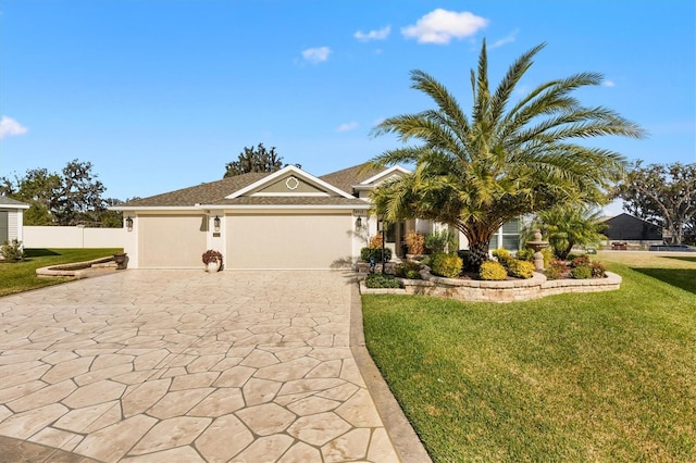 4515 Biggs Pl, The Villages, FL 32163 - ranch-style home featuring a front lawn, fence, decorative driveway, stucco siding, and an attached garage