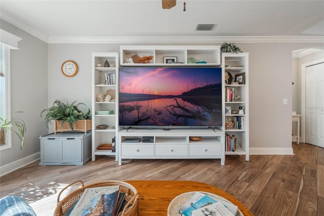 living room featuring crown molding and hardwood / wood-style floors