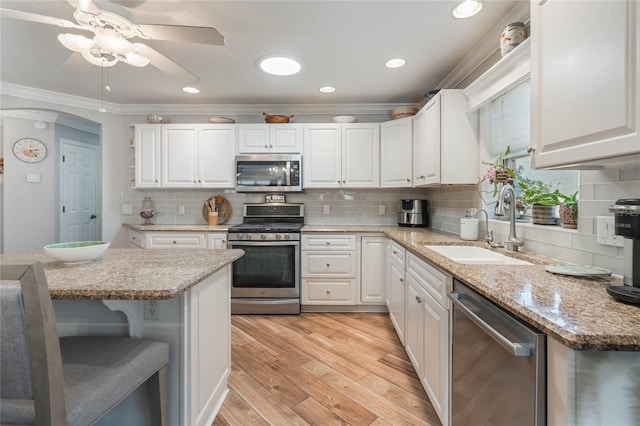 kitchen featuring white cabinetry, stainless steel appliances, and sink