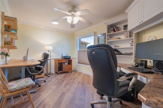 office area featuring ceiling fan, ornamental molding, light hardwood / wood-style floors, and a textured ceiling