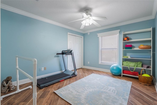 exercise area with hardwood / wood-style flooring, crown molding, a textured ceiling, and ceiling fan