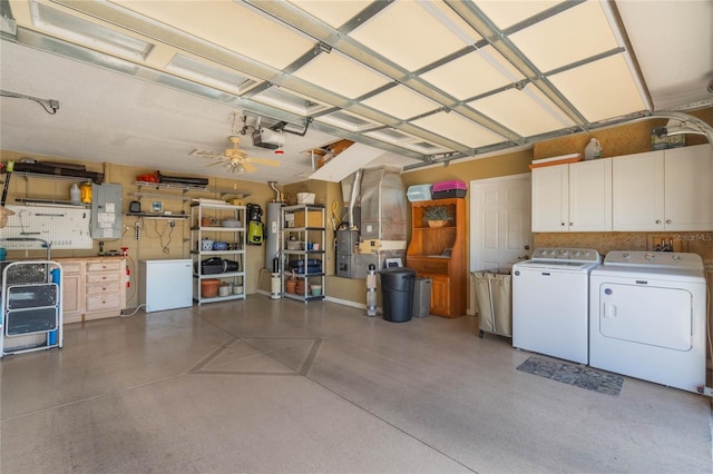 garage with a garage door opener, gas water heater, and washer and dryer