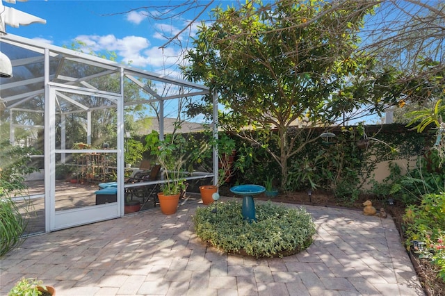 view of patio / terrace featuring glass enclosure