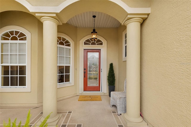 view of exterior entry with stucco siding