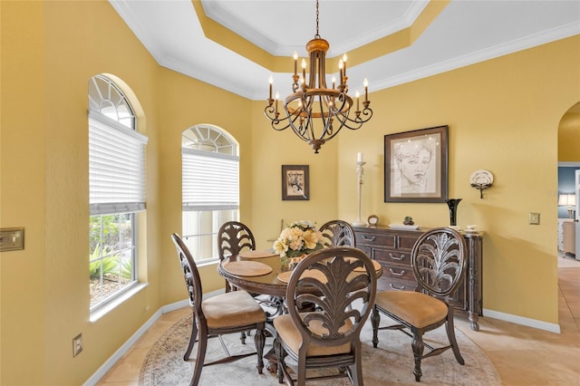 dining space featuring arched walkways, light tile patterned flooring, a raised ceiling, and crown molding