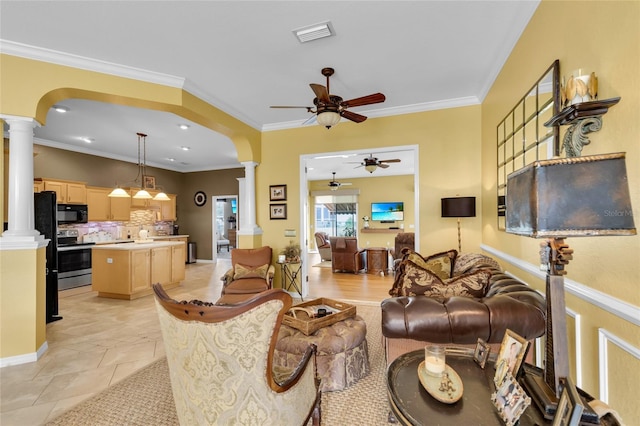 living area featuring arched walkways, visible vents, ornamental molding, ceiling fan, and ornate columns