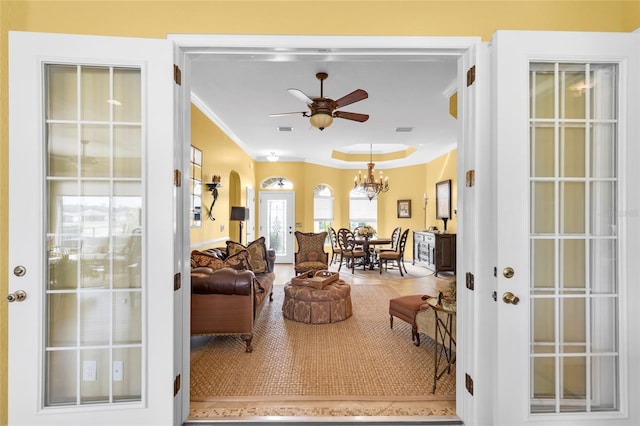 living room with arched walkways, ceiling fan, and crown molding