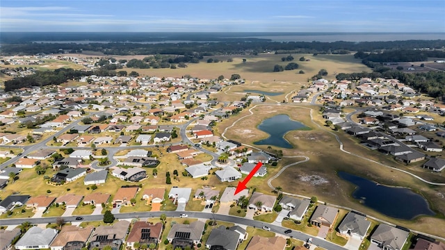 birds eye view of property with a water view and a residential view