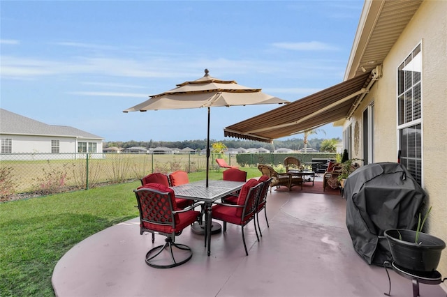 view of patio / terrace with a fenced backyard, grilling area, and outdoor dining space