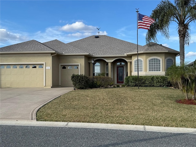 view of front of home with a garage, a shingled roof, a front yard, and stucco siding