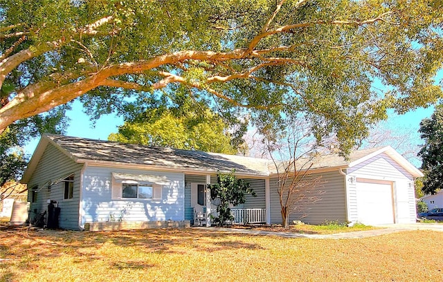 ranch-style house featuring a porch, a garage, and a front yard