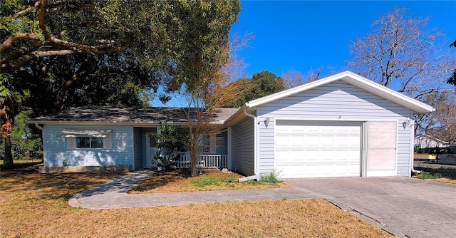 ranch-style house featuring a garage and a front lawn