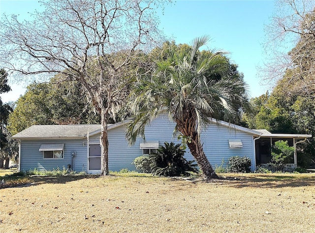 view of side of home with a yard