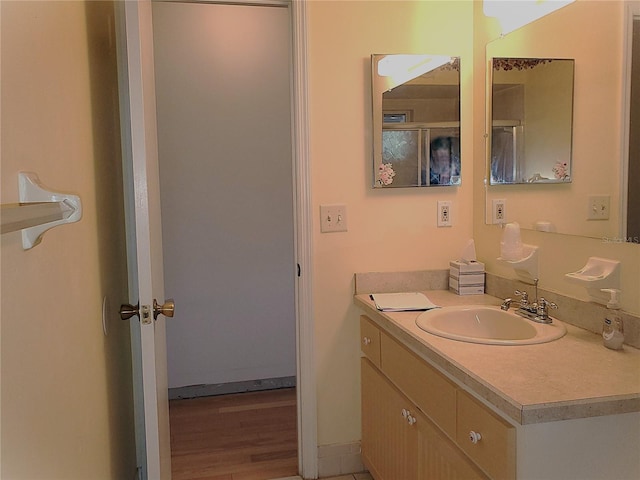 bathroom featuring hardwood / wood-style flooring and vanity