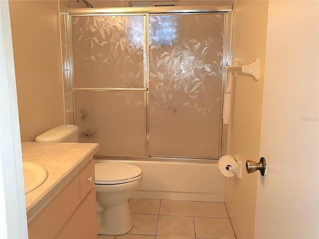 full bathroom with vanity, tile patterned floors, enclosed tub / shower combo, and toilet