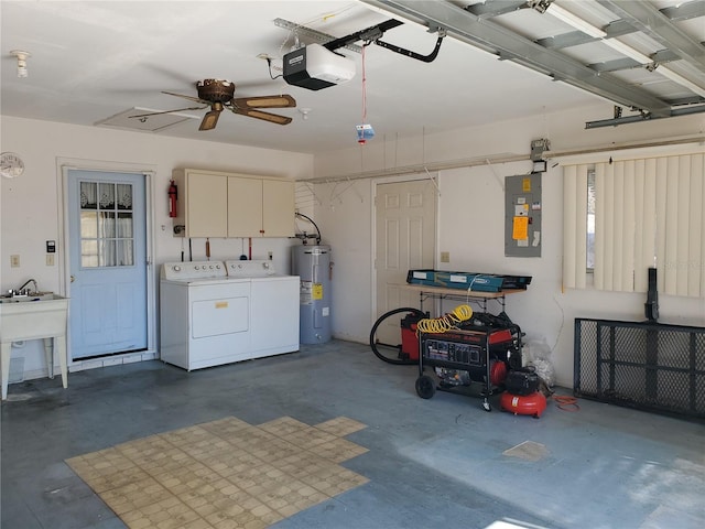 garage with a garage door opener, washing machine and dryer, electric water heater, and electric panel