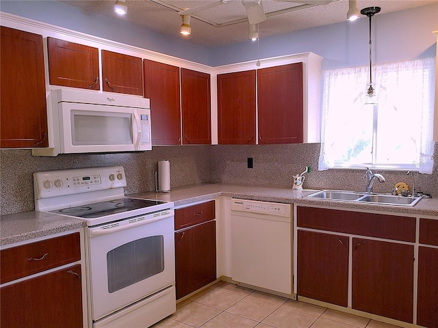 kitchen with light tile patterned floors, sink, white appliances, hanging light fixtures, and decorative backsplash