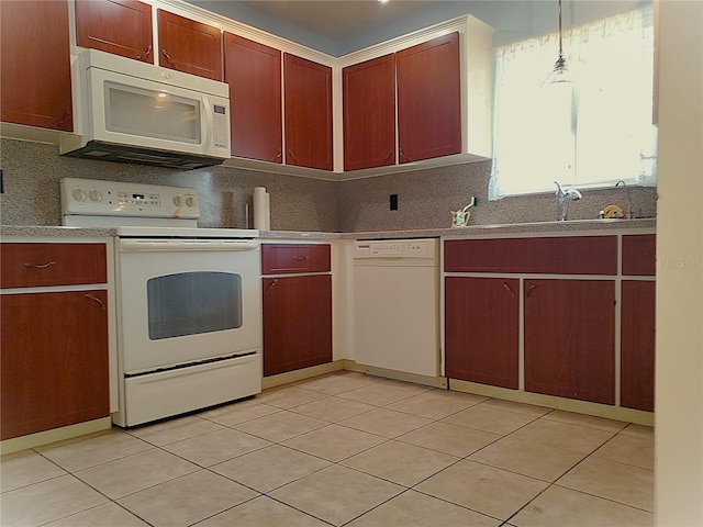 kitchen featuring sink, white appliances, hanging light fixtures, tasteful backsplash, and light tile patterned flooring