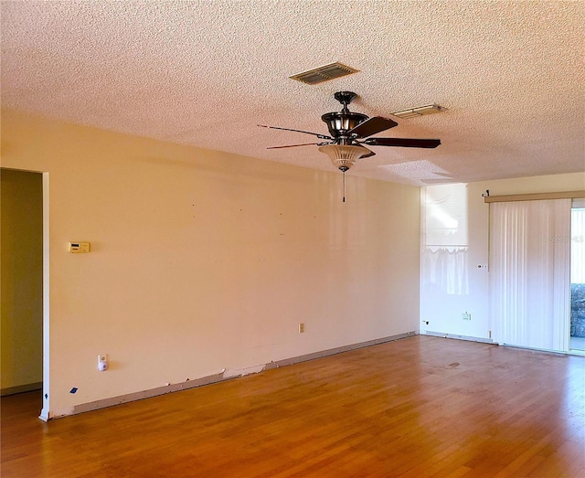 unfurnished room with hardwood / wood-style flooring, a textured ceiling, and ceiling fan