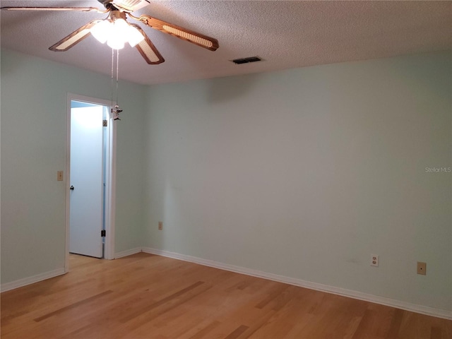 spare room featuring ceiling fan, a textured ceiling, and light hardwood / wood-style floors