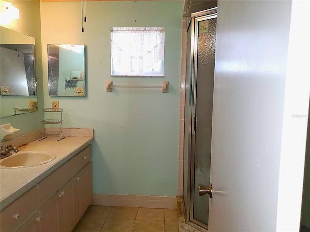 bathroom with tile patterned flooring, an enclosed shower, and vanity