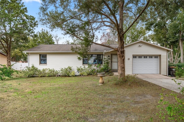 ranch-style house with a garage and a front lawn