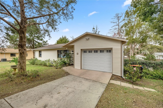 single story home with a garage and a front lawn