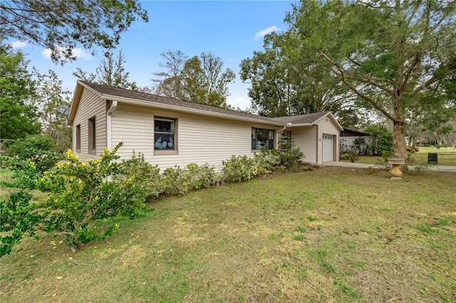 ranch-style house with a garage and a front lawn