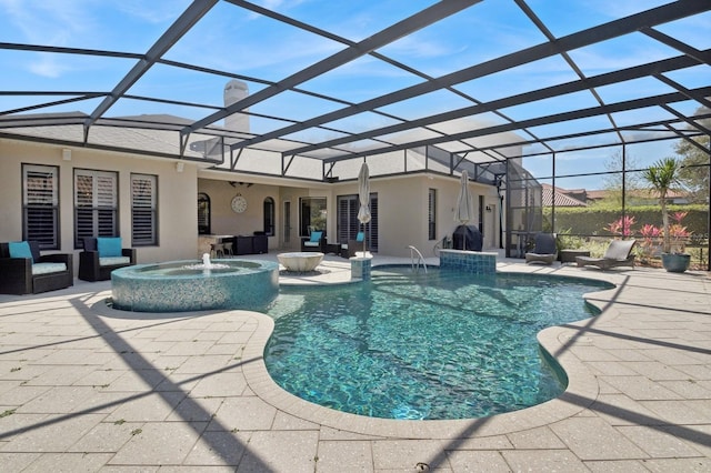 view of pool with an in ground hot tub, pool water feature, glass enclosure, and a patio area