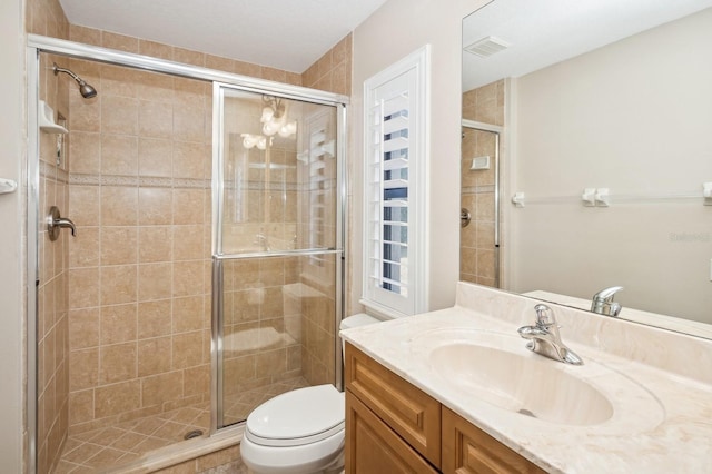 bathroom with vanity, toilet, and walk in shower