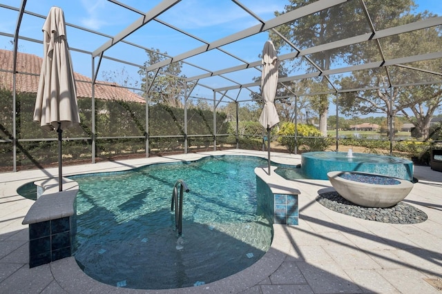 view of swimming pool featuring a hot tub, a patio, and a lanai