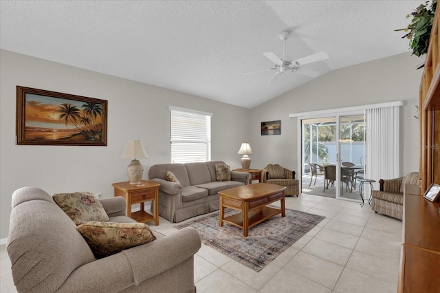 living room with vaulted ceiling, light tile patterned floors, a textured ceiling, and a wealth of natural light