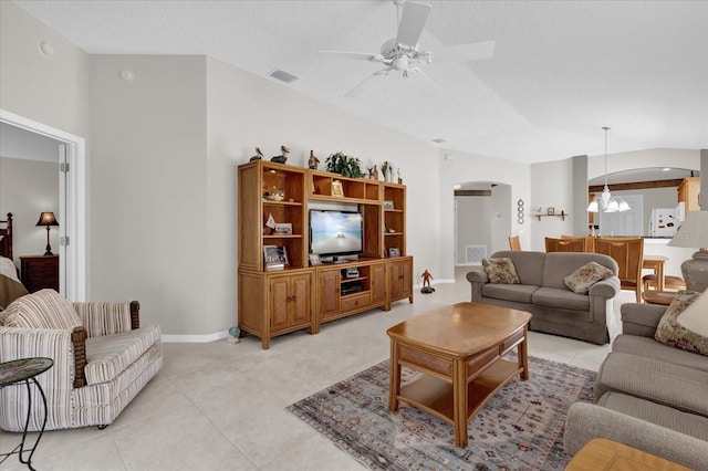 living room with lofted ceiling, light tile patterned floors, a textured ceiling, and ceiling fan