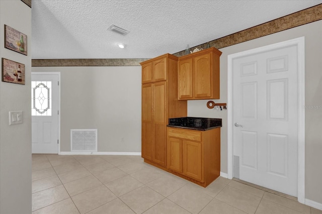 kitchen featuring light tile patterned floors and a textured ceiling