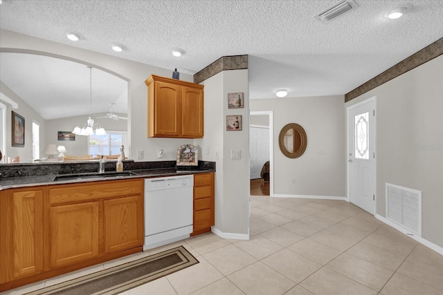 kitchen with sink, dishwasher, a textured ceiling, light tile patterned flooring, and a chandelier