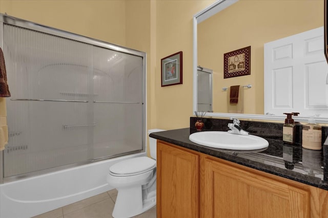 full bathroom with enclosed tub / shower combo, toilet, tile patterned floors, and vanity