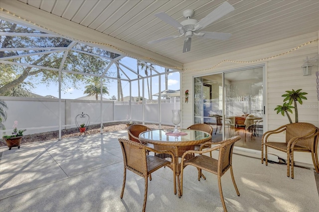 sunroom / solarium featuring ceiling fan