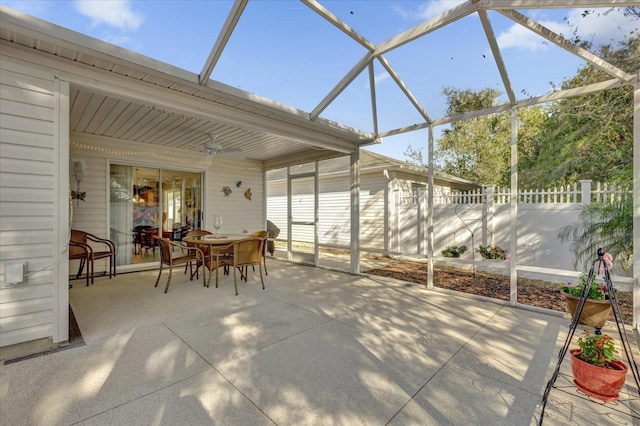 view of patio / terrace featuring ceiling fan and glass enclosure