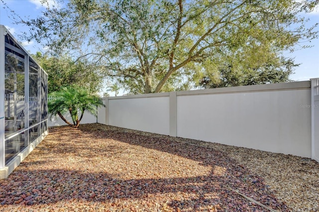 view of yard featuring glass enclosure