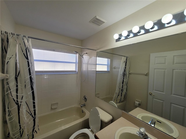 full bathroom with shower / bathtub combination with curtain, vanity, and toilet