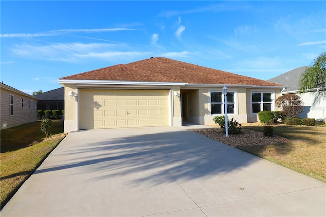 single story home with a garage and a front lawn