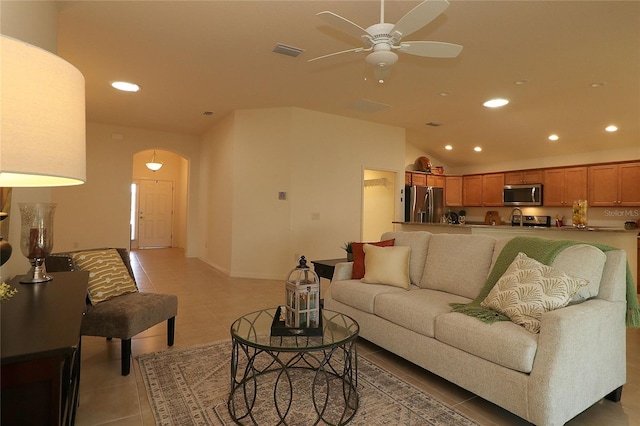 living room featuring ceiling fan, lofted ceiling, and tile patterned floors