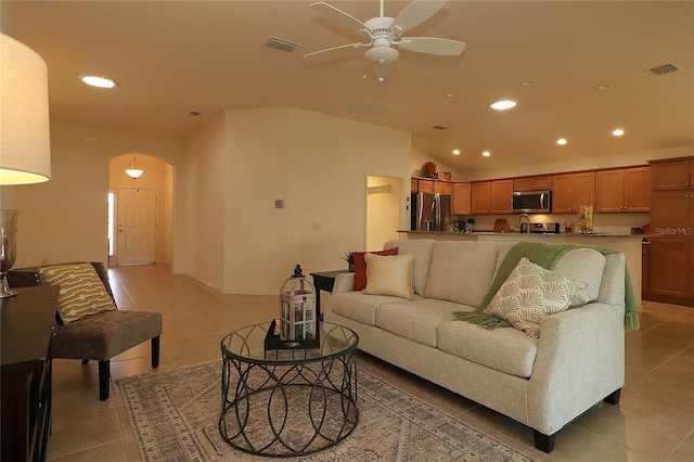 tiled living room with vaulted ceiling and ceiling fan