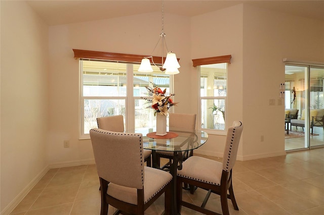 tiled dining room featuring lofted ceiling