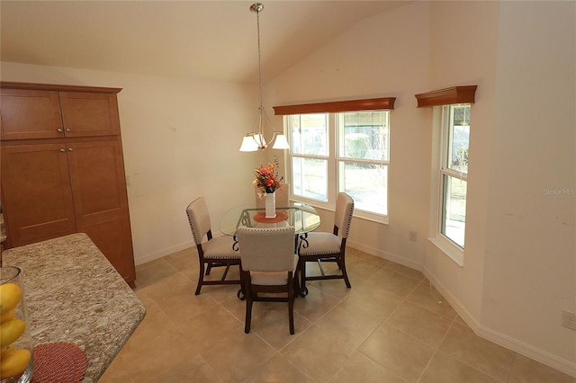 dining space with vaulted ceiling and light tile patterned flooring